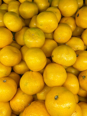 lots of yellow ripe tangerine vitamins taste fruit for food as background