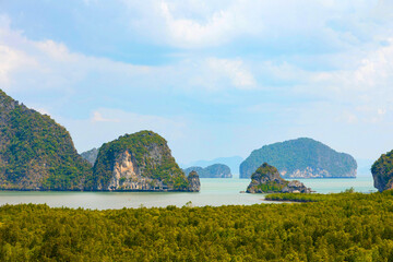 Samet Nangshe viewpoint at the south of Thailand during the daytime under the sunlight with the cloudy grey sky with the view of the rocks in Phang Nga Bay - Powered by Adobe