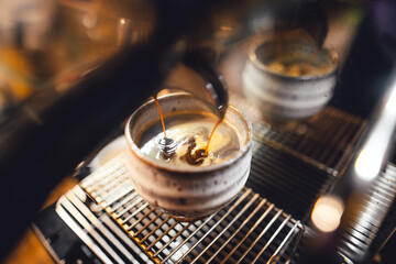 Hot coffee from the machine into the coffee cup