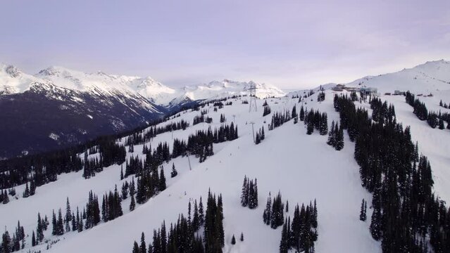 Whistler Mountain lodge and gondola at sunset, aerial drone footage, ski hill, winter mountain, vista. 4K 24FPS PRORES 422