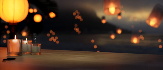 Copy space on tabletop with candles over blurred background of beautiful lanterns in the dark sky