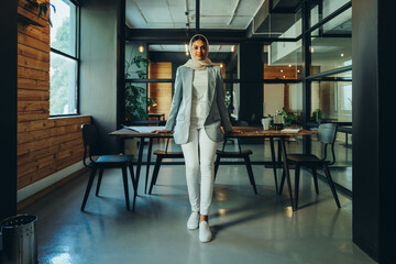 Young Islamic businesswoman standing in an office boardroom