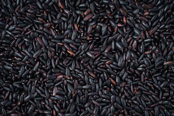 Whole grain black rice texture. Top view, close up