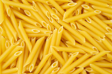 Italian pasta pennettine background. Top view, close up.