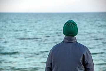 A man looks at the sea in thought	
