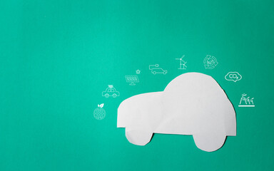 Tiny paper cars on a green background