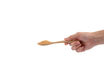 Hand holding wooden spoon on brown sugar on transparent background.