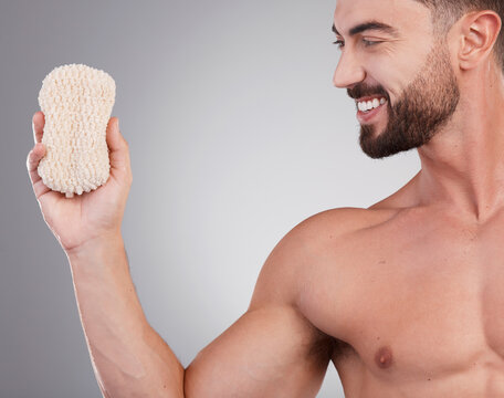 Hygiene, Man And Sponge For Cleaning, Smile And Wellness With Guy On Grey Studio Background. Male, Gentleman And Skincare For Washing, Happiness And Grooming Routine For Health, Smooth And Soft Skin