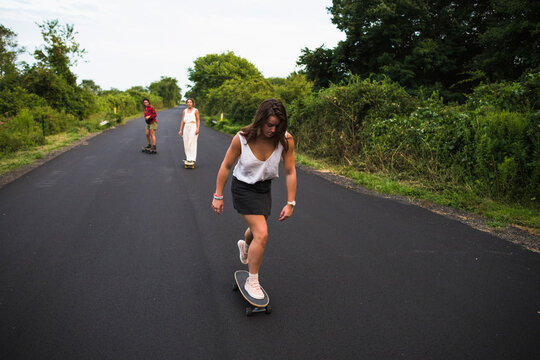Young Women Skateboarding in Summer