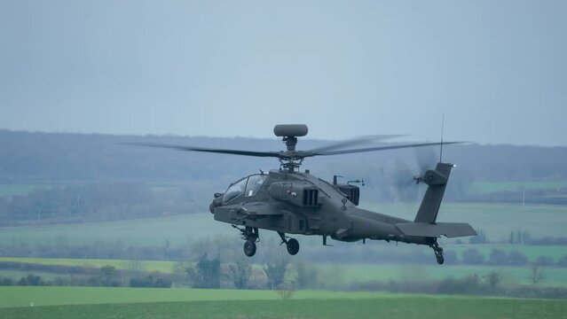 close-up of British army Boeing Apache Attack helicopter gunship (AH-64E AH64E ArmyAir606) in low level flight, Wiltshire UK