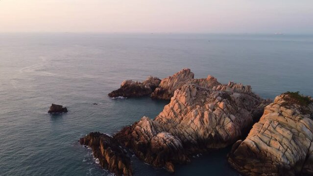 Aerial view of Daewangam and the sea in winter with people watching the sunrise, near Ulsan, South Korea.