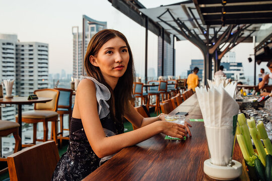 Pretty Thai Woman at a Rooftop Bar