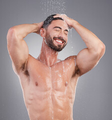 Shower, water and cleaning hair with a man in studio on a gray background for hygiene or grooming....