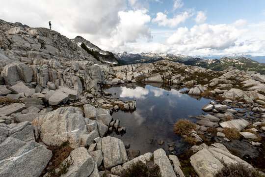 A man takes in the view of the mountains he is hiking in.