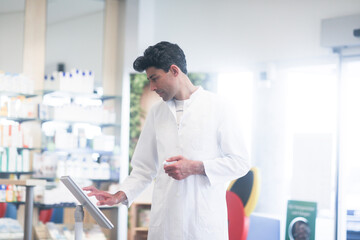 pharmacist in a pharmacy with a tablet