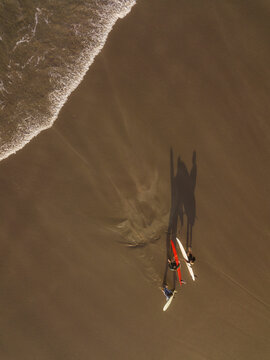 Aerial view of surfers at the beach