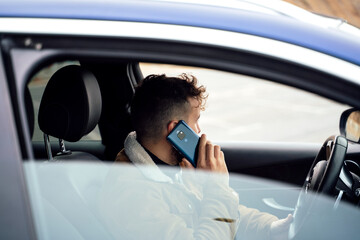 Person using his smartphone in his car