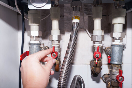 Plumbing connections of a modern domestic double-circuit gas boiler, water heater.
