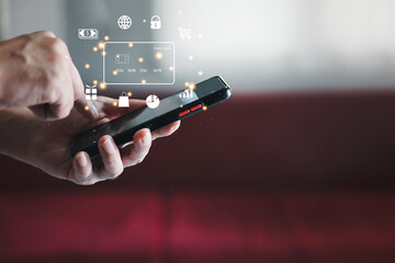 Hand holding credit card and using laptop. Businessman or entrepreneur working from home. Online shopping, e-commerce, internet banking, spending money, work from home concept.
