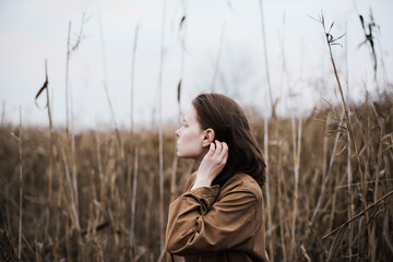 Portrait of a beautiful young woman in warm clothes outdoors