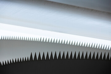 The edges of the blades of a windmill with jagged protrusions, folded for transportation.