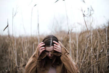 Portrait of a beautiful young woman in warm clothes outdoors