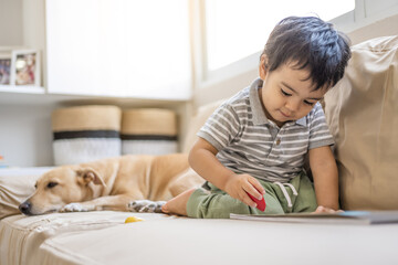 Latino boy with his mixed-breed puppy in his living room