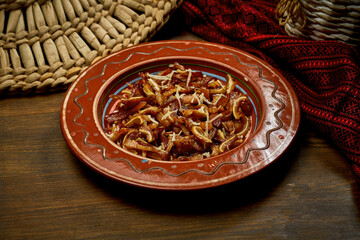 Marinated pig ears in a clay plate. Ukrainian and Korean cuisine