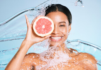 Beauty, skin care and woman portrait with a grapefruit for healthy skin and diet on blue...