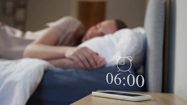 A woman wakes up from an alarm clock on her smartphone and touches it, feeling irritated and wanting to sleep.