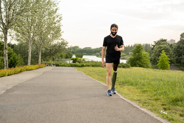 Details of a walk of a young man with prosthetic leg, young man with art and foot mechanic trains to walk at park, different posture