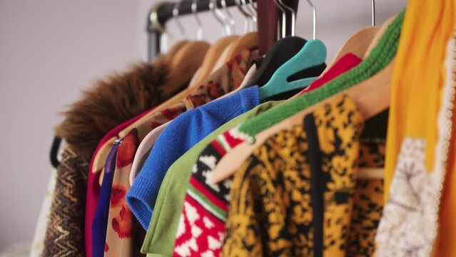 Colorful clothes hanging on a clothes rack. Close up, rack focus.