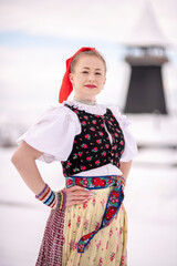 Young beautiful slovak woman in traditional dress. Slovak folklore