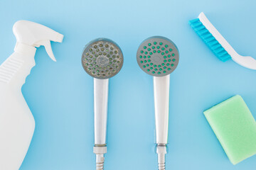 Detergent bottle, brush, sponge for shower head cleaning on pastel blue table background. Limescale removing. Closeup. Problem and solution. Compare two objects with and without limestone. Top view.