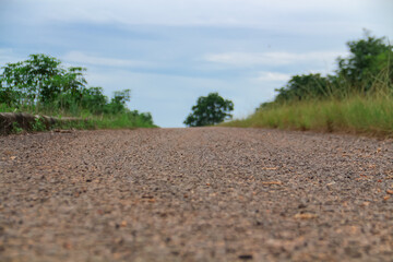 Road in the countryside with green grass and blue sky