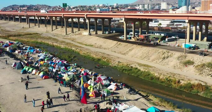 Venezuelan migrants as they stand at the El Paso border, facing a river that stands in the way of their American dream.
