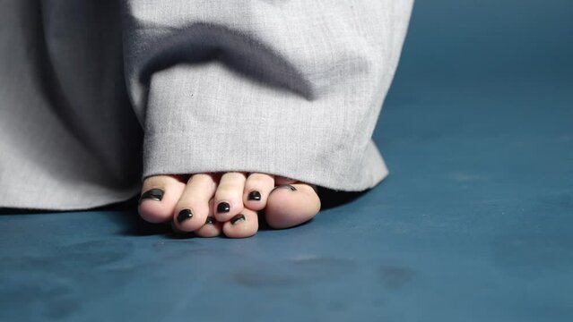 Close up of Barefoot Female Curling Toes