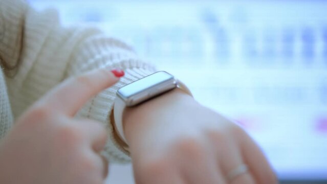 Womans hand touching a smart watch. Smart watch on a womans hand indoor