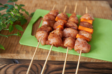 Chicken breast kebabs in marinade, close-up, top view. 