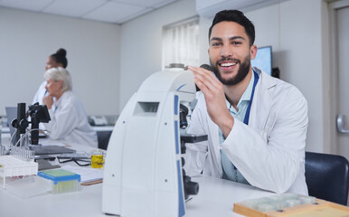Man, microscope and portrait of scientist in laboratory for research, experiment or innovation. Science, technology or smile of happy male doctor with medical equipment for sample analysis or testing
