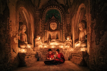 Two buddhist Monk in a pagoda in Bagan Myanmar - obrazy, fototapety, plakaty