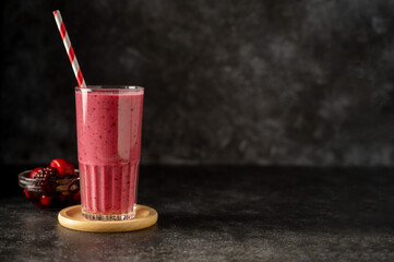 Berry smoothie milk shake drink with fresh fruits. Dark background