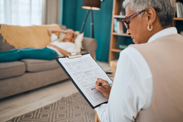Woman lying on sofa, therapist writing notes on clipboard for mental health advice and consulting in office. Stress, anxiety and depression, sad person and psychologist in patient consultation room.