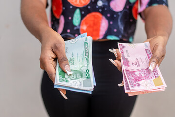 a lady holding the new nigerian naira notes