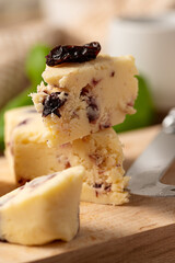 Close up cheese slices with berries. Rustic background 
