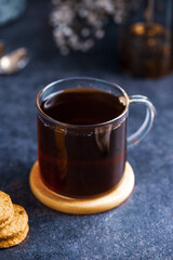 Hot black tea in glass cup, hot comfort drink