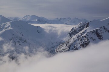 Amazing scenery of snowy clouds in clouds from Kasprowy Wierch Peak in Tatras Mountains. Tatra...