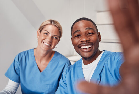 Selfie, healthcare and collaboration with friends posing for a picture together in a hospital. Portrait, teamwork or diversity with a man and woman friend in medicine taking a photograph in a clinic