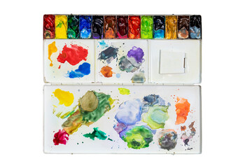 Metal watercolor palette box with colorful watercolor set on wood background.