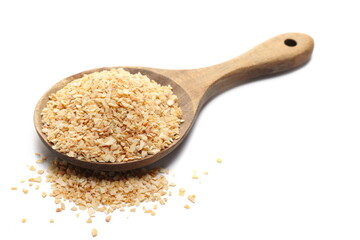 Chopped dry garlic pile in wooden spoon, isolated on white, side view